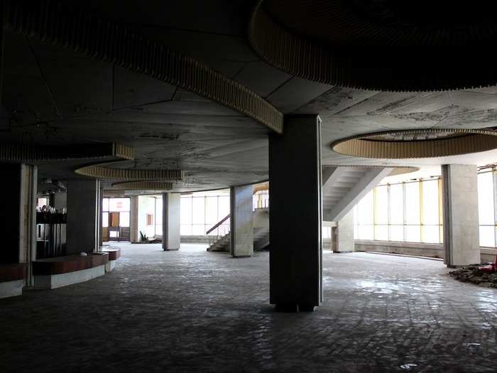 Stepping inside the circus foyer: a grand, modernist space now shrouded in shadows.