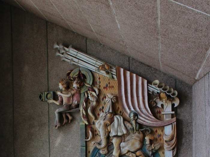 Adorning the arch above a staircase, a grand mural details circus animals such as elephants, tigers and monkeys.