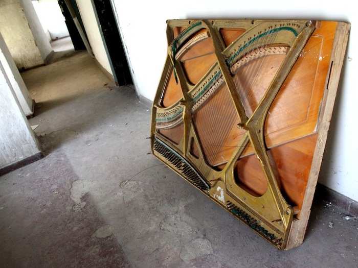 The soundboard of a piano lies abandoned in one of the backstage corridors near the top of the building.