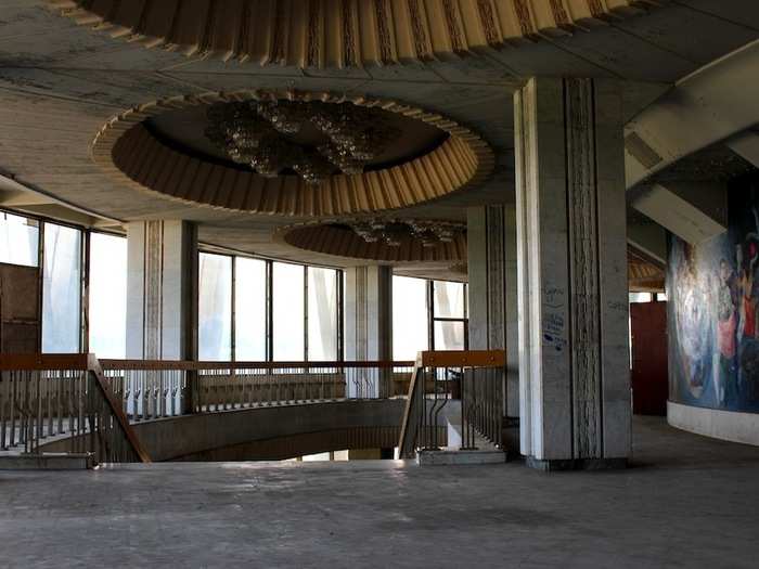 Grand light fixtures and wall murals decorate the impressive foyer area of the circus building.