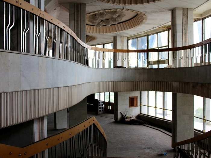 Ornate balconies and curved staircases define the foyer area in a striking, modernist style.