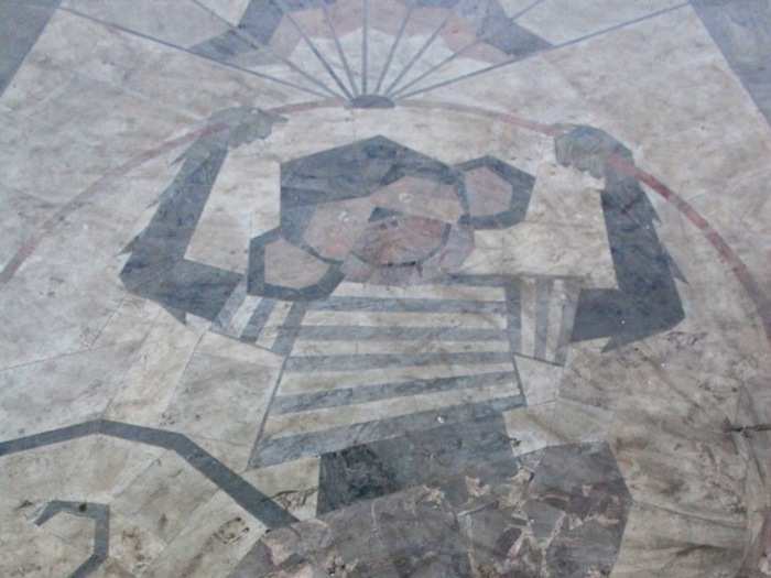 A performing monkey appears in the marble finish of the foyer floor.