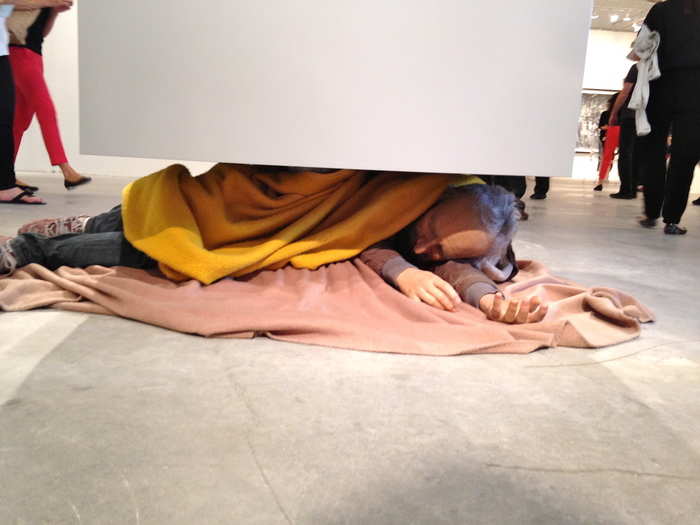 A sculpture of a sleeping man took over the center of one hallway at the fair.