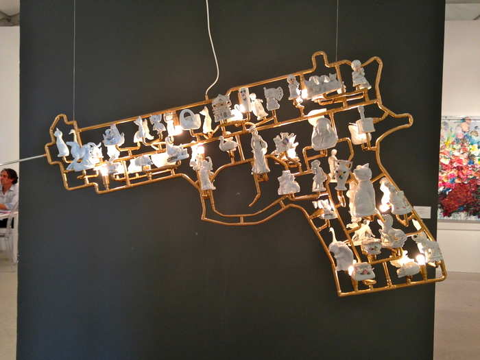 From afar, this Marcello Segall piece is just a gold and white gun.