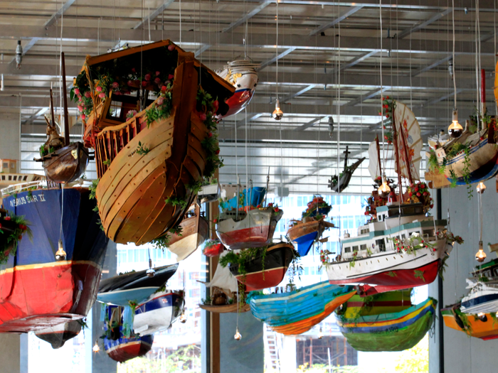 These boats by Hew Locke in the Perez Art Museum Miami were made to look like they are floating from above.