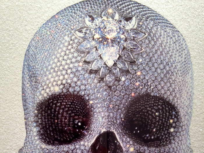 Damien Hirst "For the Love of God — White Skull" is a silk screen print with DIAMOND DUST that goes for $3,070.