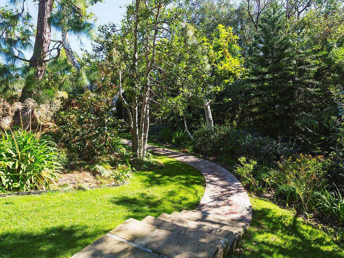 It sits on 1.6 acres of impeccably manicured land, and has stone paths running across the property.