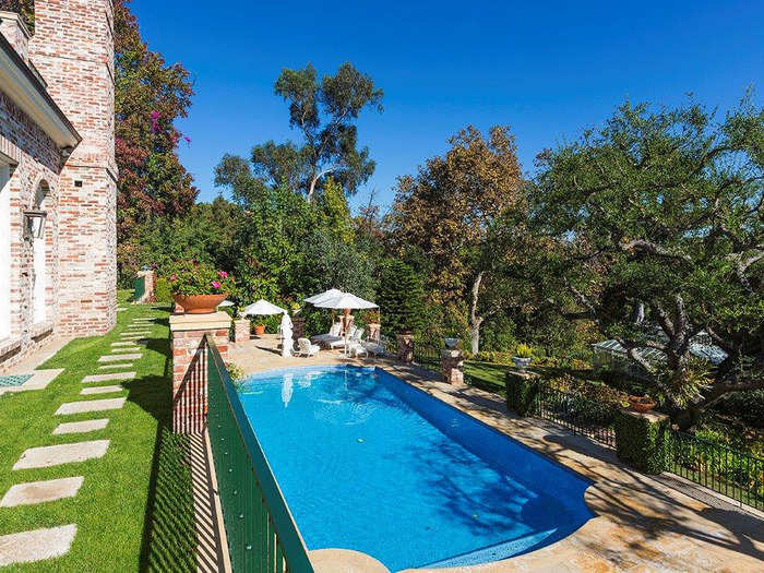 The infinity pool in the backyard is a stunning aspect of the home.