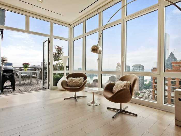 The apartment offers 10 foot ceilings and wall of glass windows giving the place plenty of natural light.