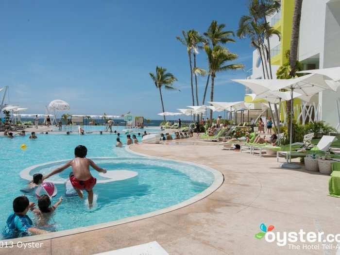 REALITY: Instead of an attractive lady and a quiet pool, guests will find crowds, kids, and even aerobics classes.