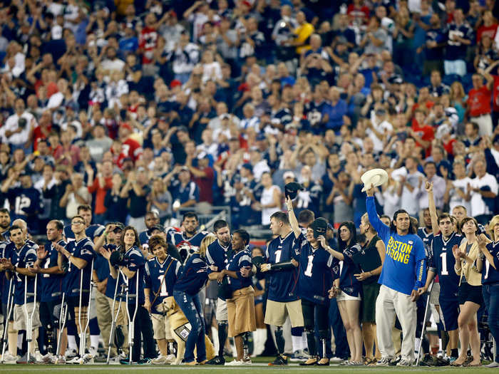 Boston Marathon bombing victims take the field before a New England Patriots game.