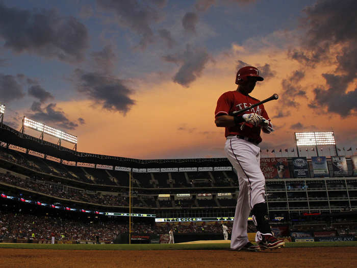 The sun sets over a Texas Rangers game.