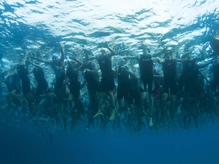 Triathletes wait for the start of the swim portion of an Iron Man.