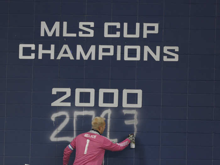 Sporting KC goalie Jimmy Nielsen spray paints "2013" after his team defeated Real Salt Lake in the MLS Cup.