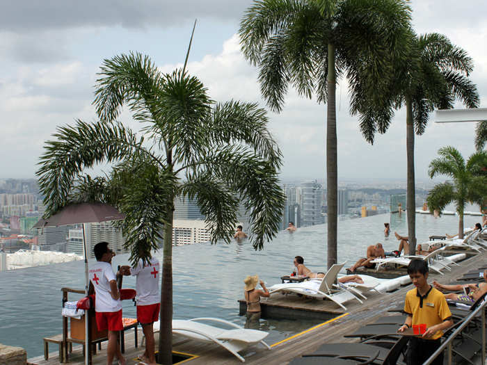 Lifeguards watch over swimmers in the pool.