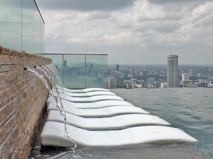 There are chaise lounges directly in the pool, under a waterfall.