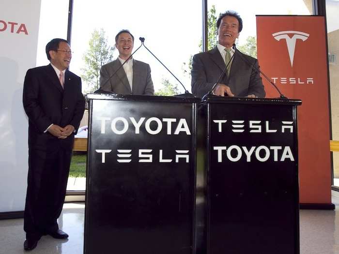 He shared a laugh with California Governor Arnold Schwarzenegger and Toyota CEO Akio Toyoda at a press conference announcing Toyota would take a $50 million stake in Tesla.