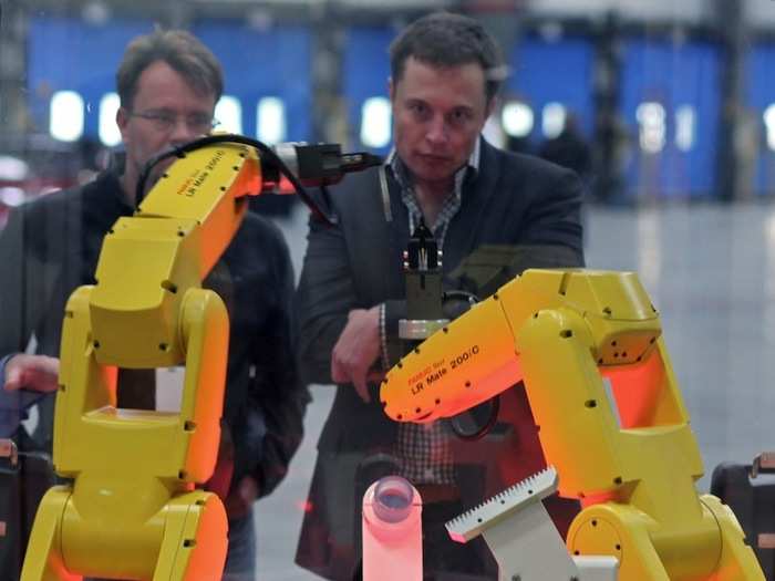 Elon Musk stares down robots.