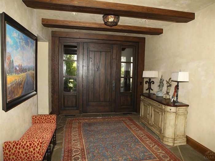 The wood-finished front door and foyer