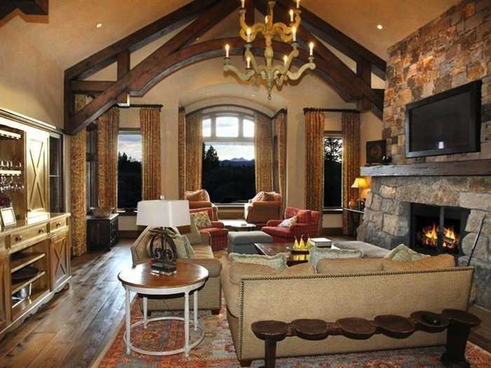 This is the luxurious family room with a stone fireplace