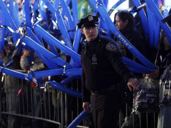 Police officers start letting revelers into the pens before 6:00pm.