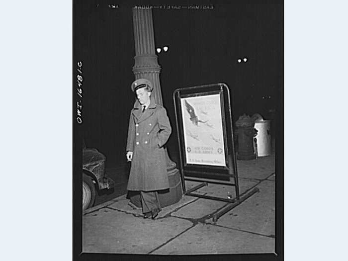 1942: A lonely soldier stands next to a recruitment sign on New Year