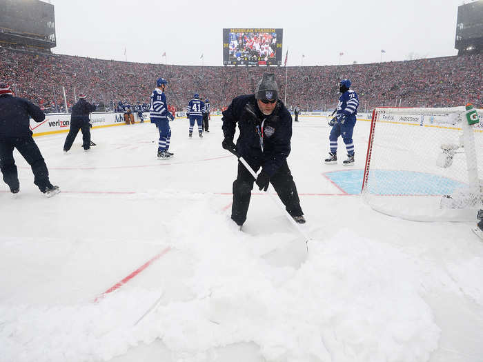 Snow had to be shoveled off the ice before the game.