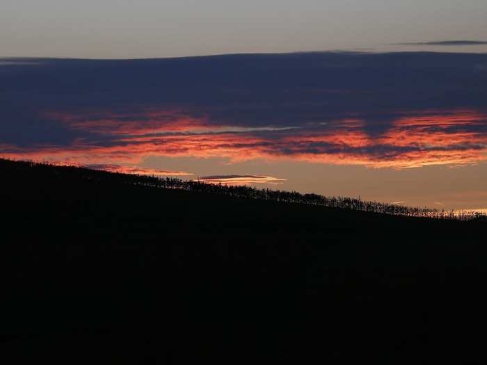 The sun sets over the hills of Serralunga d