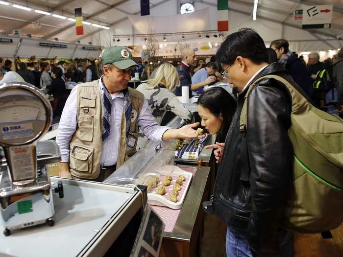 For a few days each November, truffle connoisseurs travel to Alba to participate in the World White Truffle Auction. Here, a seller shows his wares to potential customers.