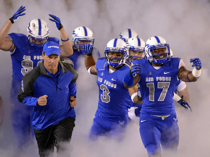 U.S. Air Force Academy Falcons Head Coach Troy Calhoun leads the team into the stadium to play conference rival Wyoming at Falcon Stadium in Colorado Springs, Colo. The Cowboys defeated Air Force 56-23. (Department of Defense photo/Mike Kaplan)