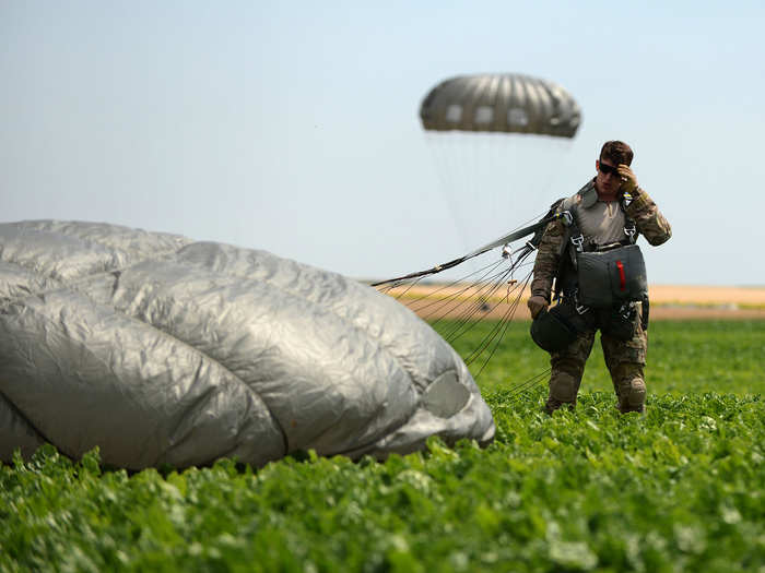 Senior Airman Justin Gordon completes a static line jump at Spangdahlem Air Base, Germany. Gordon participated in the training to maintain his qualifications and also reenlisted prior to the jump. He