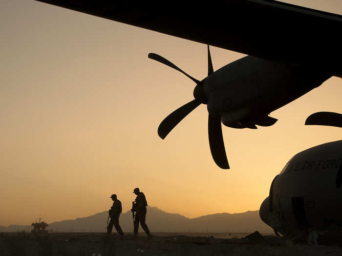 Airman 1st Class Christian Mejia and Staff Sergeant Duron Arnold, 376th Expeditionary Security Forces Squadron Fly Away Security Team members, perform a security check around a disabled C-130 Hercules aircraft at Forward Operating Base Shank, Logar Province, Afghanistan, June 6, 2013. Mejia and Duron are forward deployed from Manas Air Base, Kyrgyzstan.