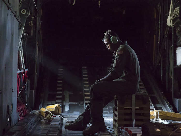 Airman 1st Class Wynthom Thomas communicates with pilots after landing Yokota Air Base, Japan. Seven C-130 Hercules flew in formation practicing airlift tactics and procedures. Thomas is a loadmaster assigned to the 36th Airlift Squadron at Yokota AB. (U.S. Air Force photo/Osakabe Yasuo)