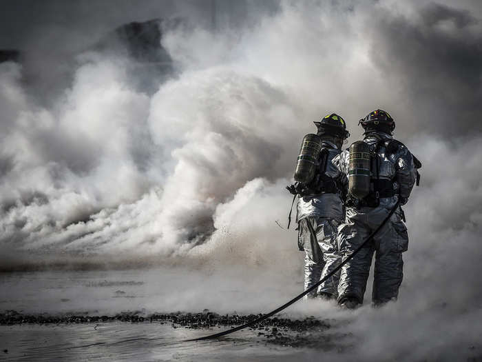 Firefighters from the 366th Civil Engineer Squadron extinguish a fire during a fire training exercise at Mountain Home Air Force Base, Idaho. Two teams worked in unison to push the fire back without it reigniting behind them. The training exercise was one component of a base-wide operational readiness exercise.(U.S. Air Force photo/Tech. Sgt. Samuel Morse)