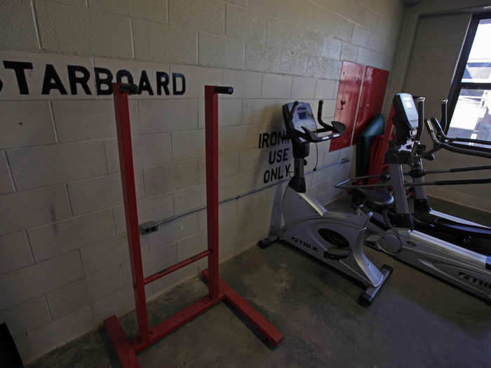 Further toward the front of the bay is the quarterdeck, part of which is set aside for a small "gym."