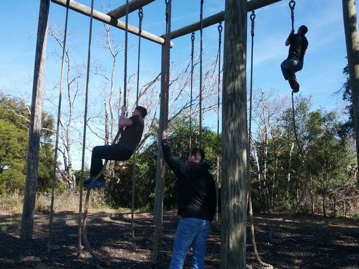 Outside I climb the rope at the end of the obstacle course, for old time