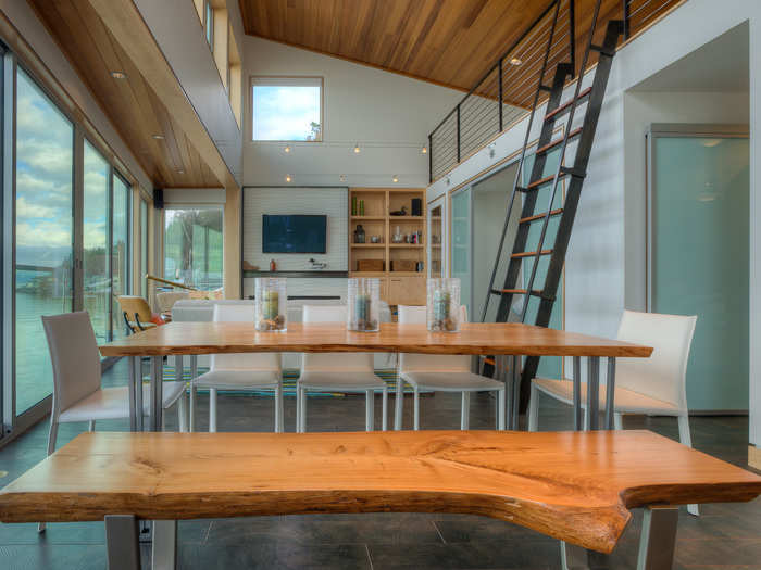 The steel stairs save space and lead to a small 198-square-foot loft area that has a guest bedroom.