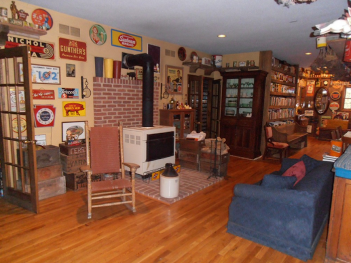 The living room is cozy, complete with a wood stove.