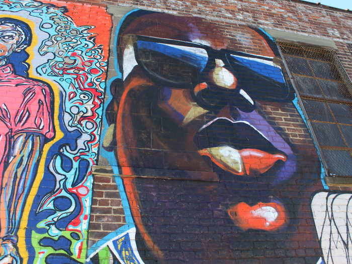 Here, Biggie Smalls is painted next to a portrait of Joseph Ficalora