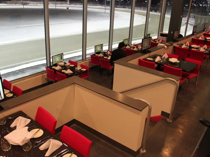 Pink, the two-tiered public dining room, looks out at the finish line of the mile-long track.