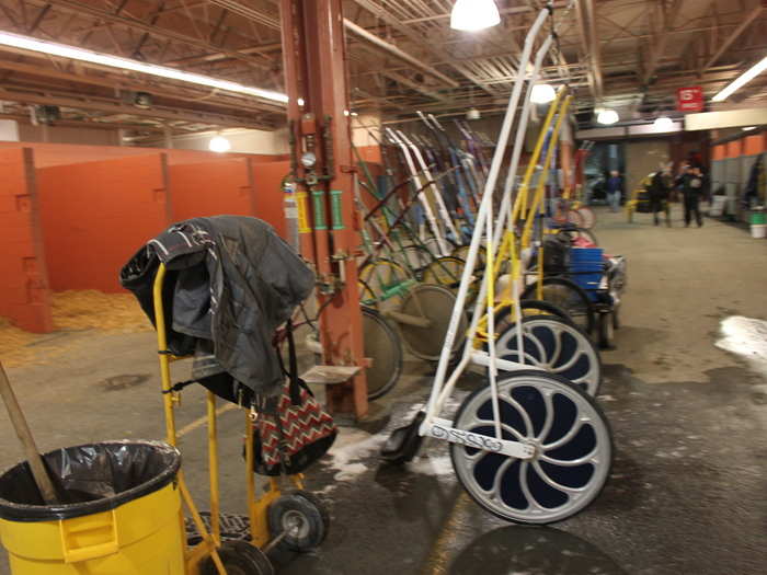 These are the jog carts lined up before the drivers hitch them to their horses for the race.