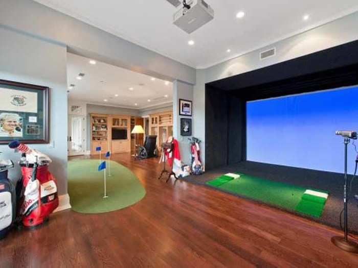 A secret stairway in the master suite takes you down to a putting green with a golf simulator.