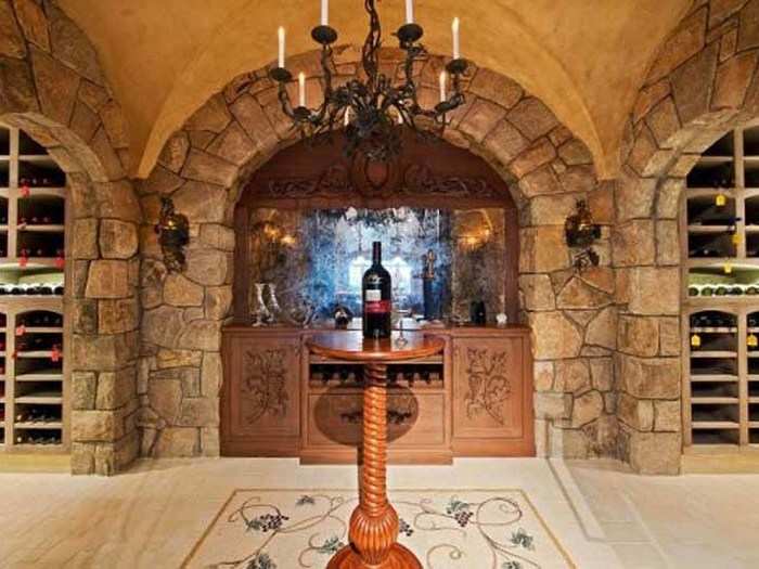 The wine cellar has antique glass walls and an Italian mosaic tiled floor.