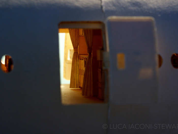 Another door swings open to reveal a closer look inside the fuselage, at a galley unit.