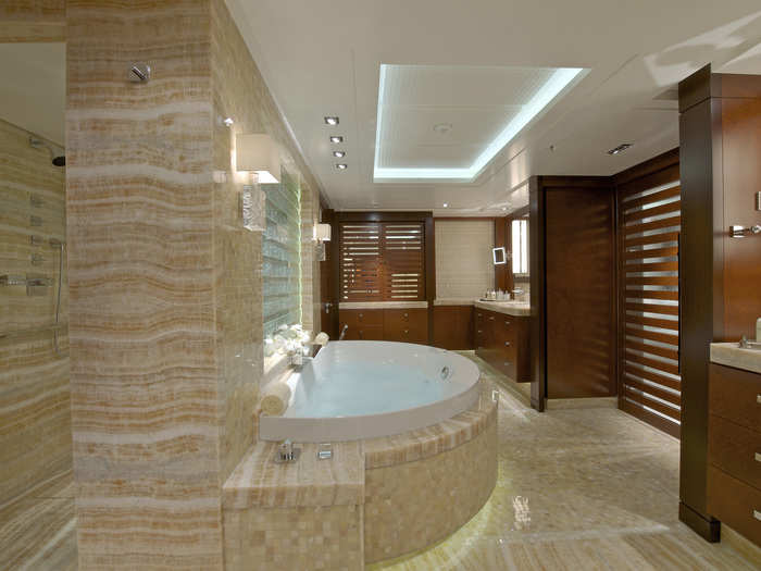 The gorgeous master bathroom has a full-body shower, soaking tub, and his and hers sinks.