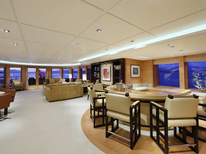 The living room stretches nearly the length of the deck and includes a bar and informal dining area.