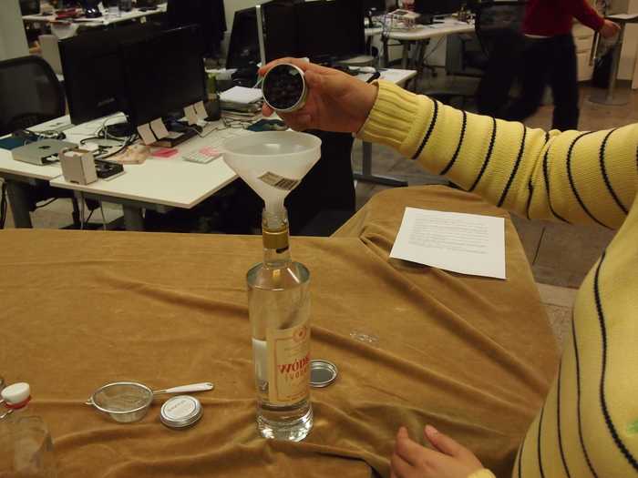 Use the funnel to get the berries inside the vodka bottle.