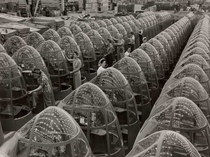 Women work at an airplane assembly plant in 1942. With men off at war, women took up factory jobs, with 2.8 million in war production that year.