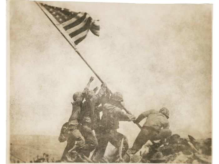 Five Marines and one Navy corpsman raise Old Glory on Mount Suribachi after taking Iwo Jima in 1945.