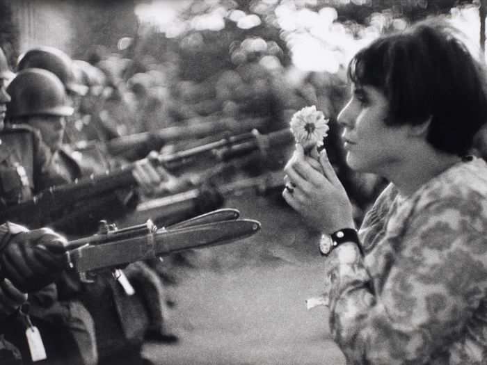 A Vietnam War protester brings a flower to soldiers in Washington D.C., on Oct. 21, 1967. Nearly 100,000 people came out to protest.